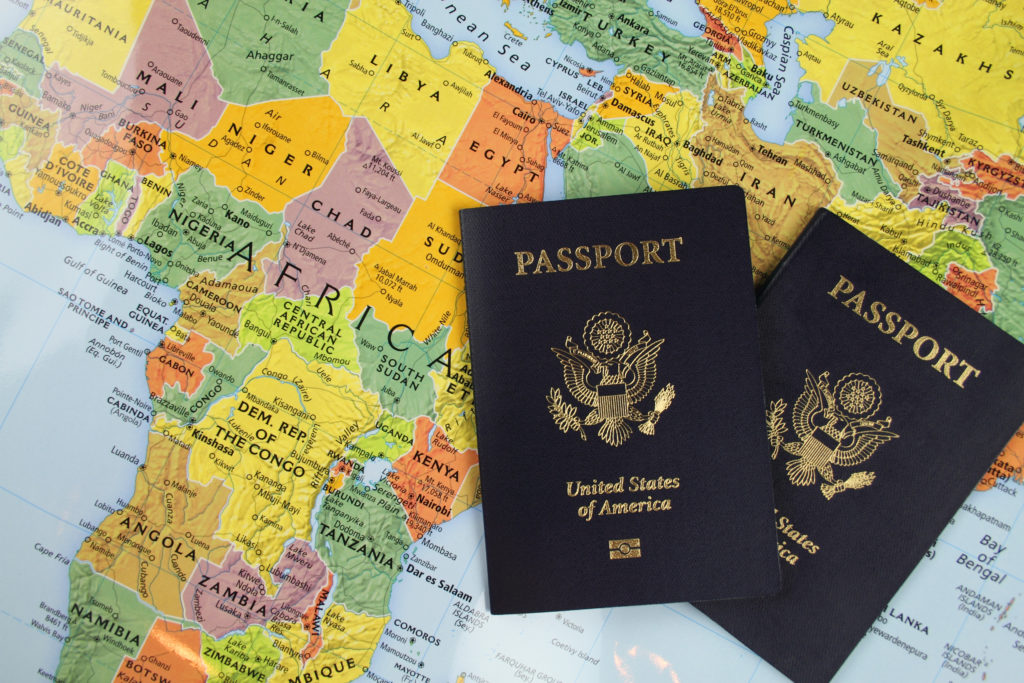 two passports over a map of the world.