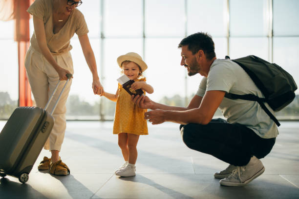 family at the airport with child holding a passport. Child Passport expiration.