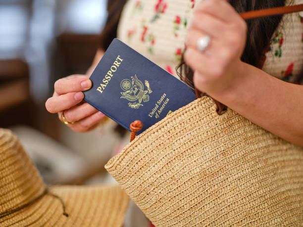 A woman putting her passport in her bag | places to get a passport near me