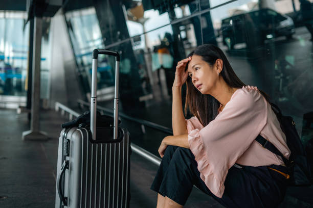 woman sits in growing frustration at the airport terminal \ How to Report a Stolen Passport and What to Do If It Was Found